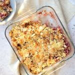 Delicious homemade peach almond crumble baked to perfection in a glass dish, perfect for dessert lovers.