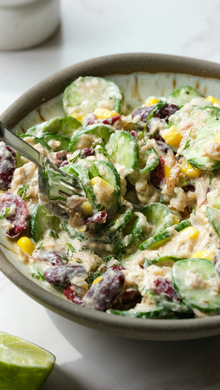 A delicious creamy vegetable and tuna salad with diverse ingredients, perfect for a healthy meal.