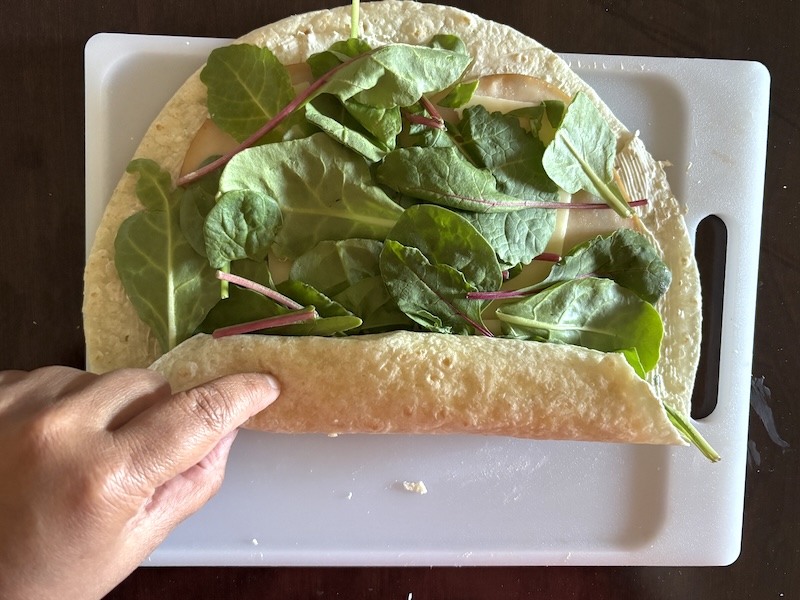 Rolling up the spinach turkey cream cheese pinwheels