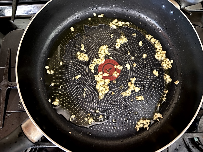 Adding garlic to the skillet