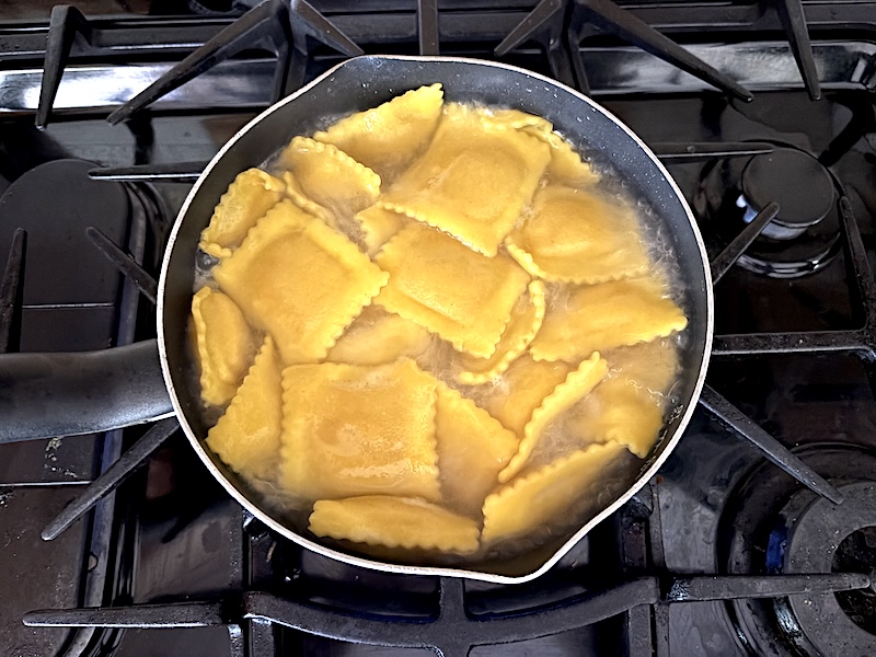 Adding the butternut squash ravioli to the boiling water