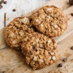 Tasty oatmeal cookies with chocolate chips on a wooden board, ready to enjoy.