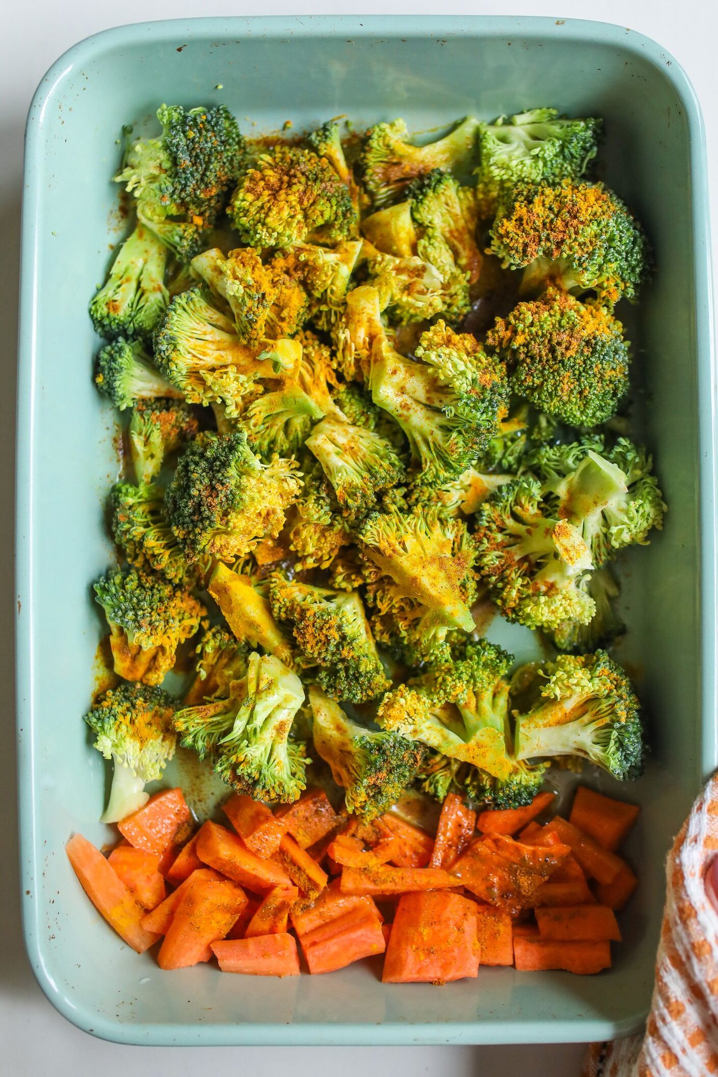 Healthy roasted broccoli and carrots in a baking tray, perfect for nutritious meals.